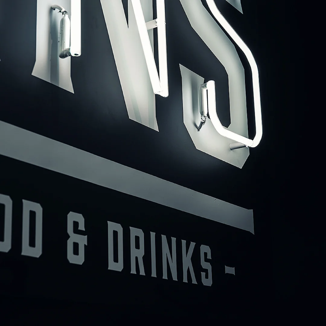 Projeto DANS da Nhdesign: Detalhe do letreiro luminoso DANS em preto e branco