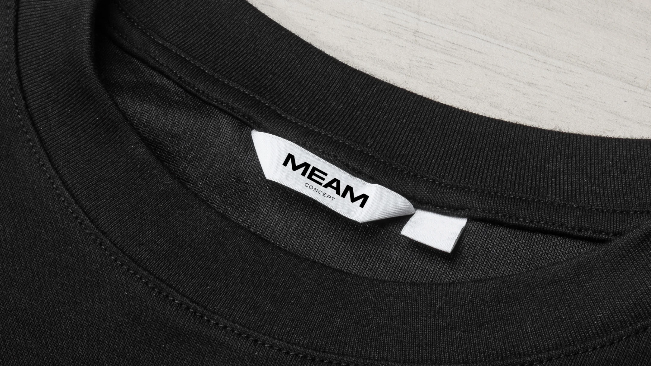 Nhdesign project Meam Concept: Label with the Meam Concept logo on a black t-shirt