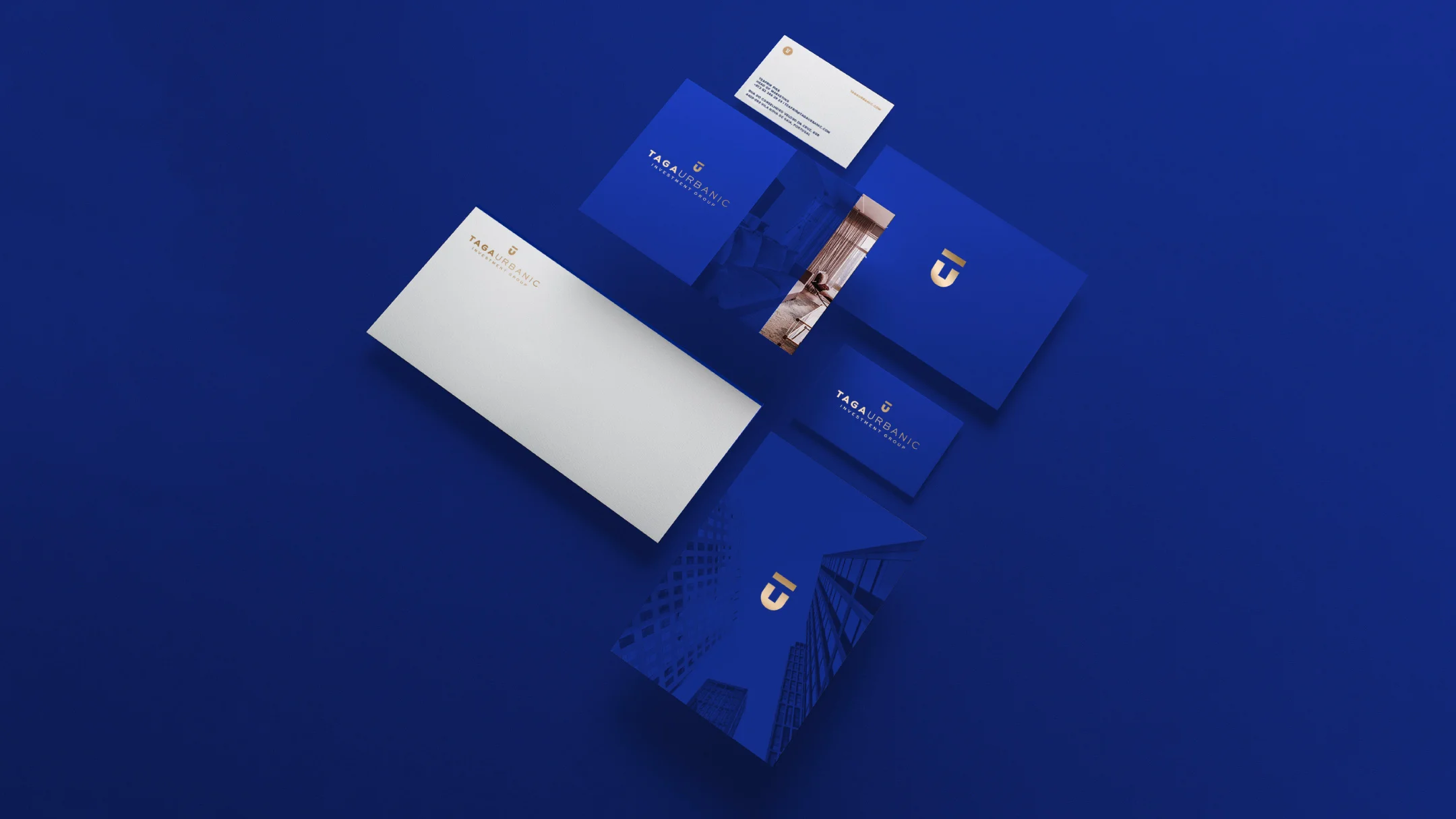 Nhdesign project Taga Urbanic: Image of Taga Urbanic's stationery on a blue background: business cards, envelopes, and flyers.