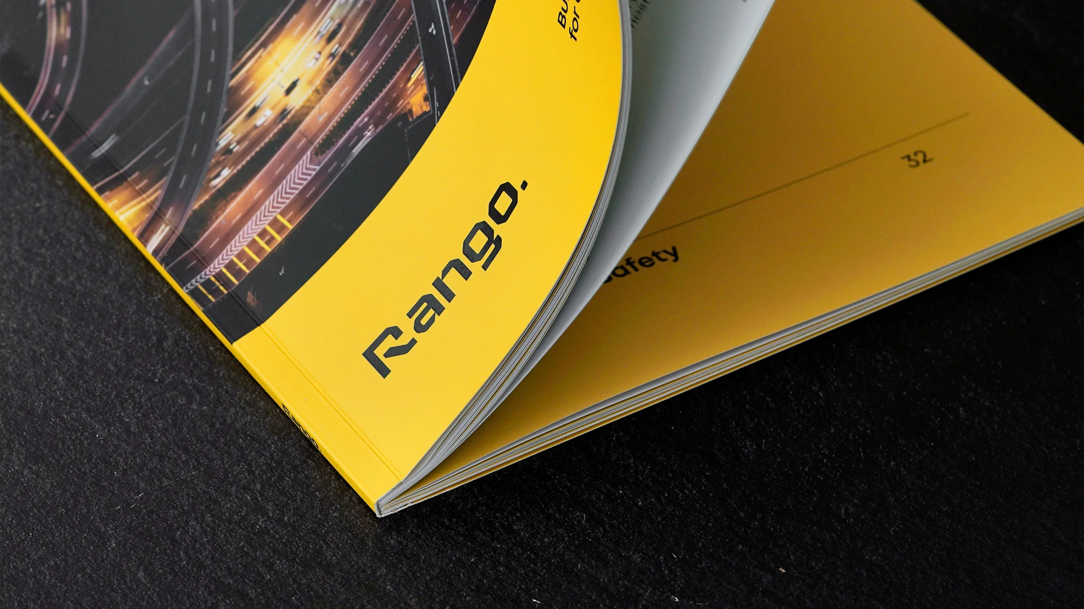 Nhdesign project Rango Company Profile: Open company profile in perspective, with black background.